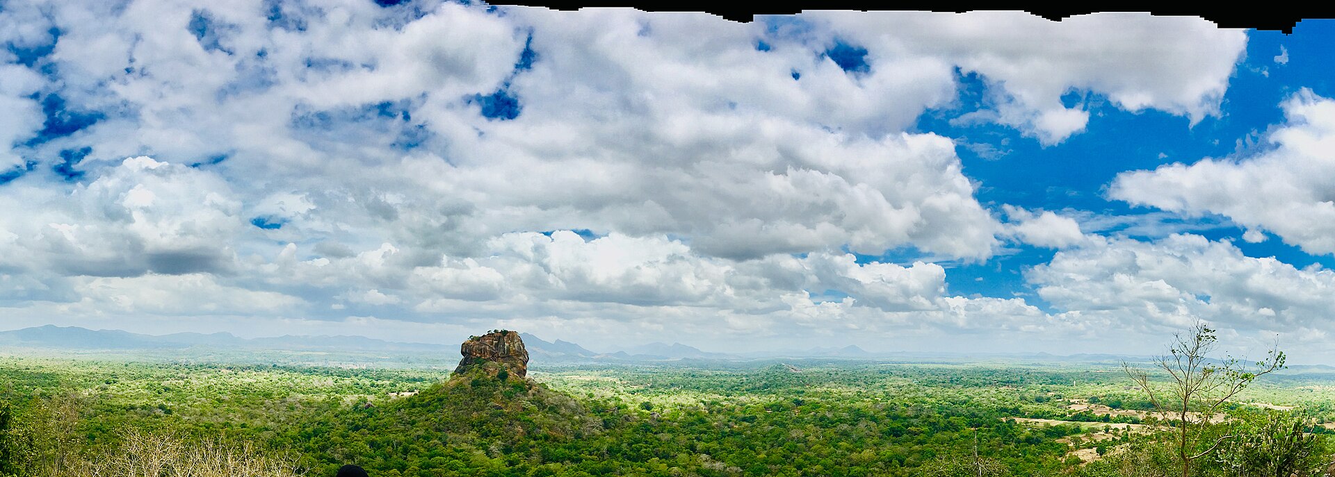 The Sigiriya Rock Fortress rising above the green plains of Sri Lanka's Cultural Triangle — the first stop on a five-day route